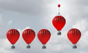 An image of four red parachutes, with one parachute carrying an additional balloon on top, flying higher than the others—symbolizing competitive advantage. Image from www.wintek.in